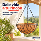 Maceta colgante tipo cesta hemisférica con forro de fibra marrón y estructura metálica negra de arcos entrelazados; tres cadenas negras al gancho superior, 31 cm diámetro y 15 cm profundidad. — portada Vendalia