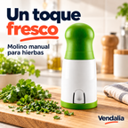Molino manual verde y blanco para hierbas con mecanismo de corte. Portada Vendalia.